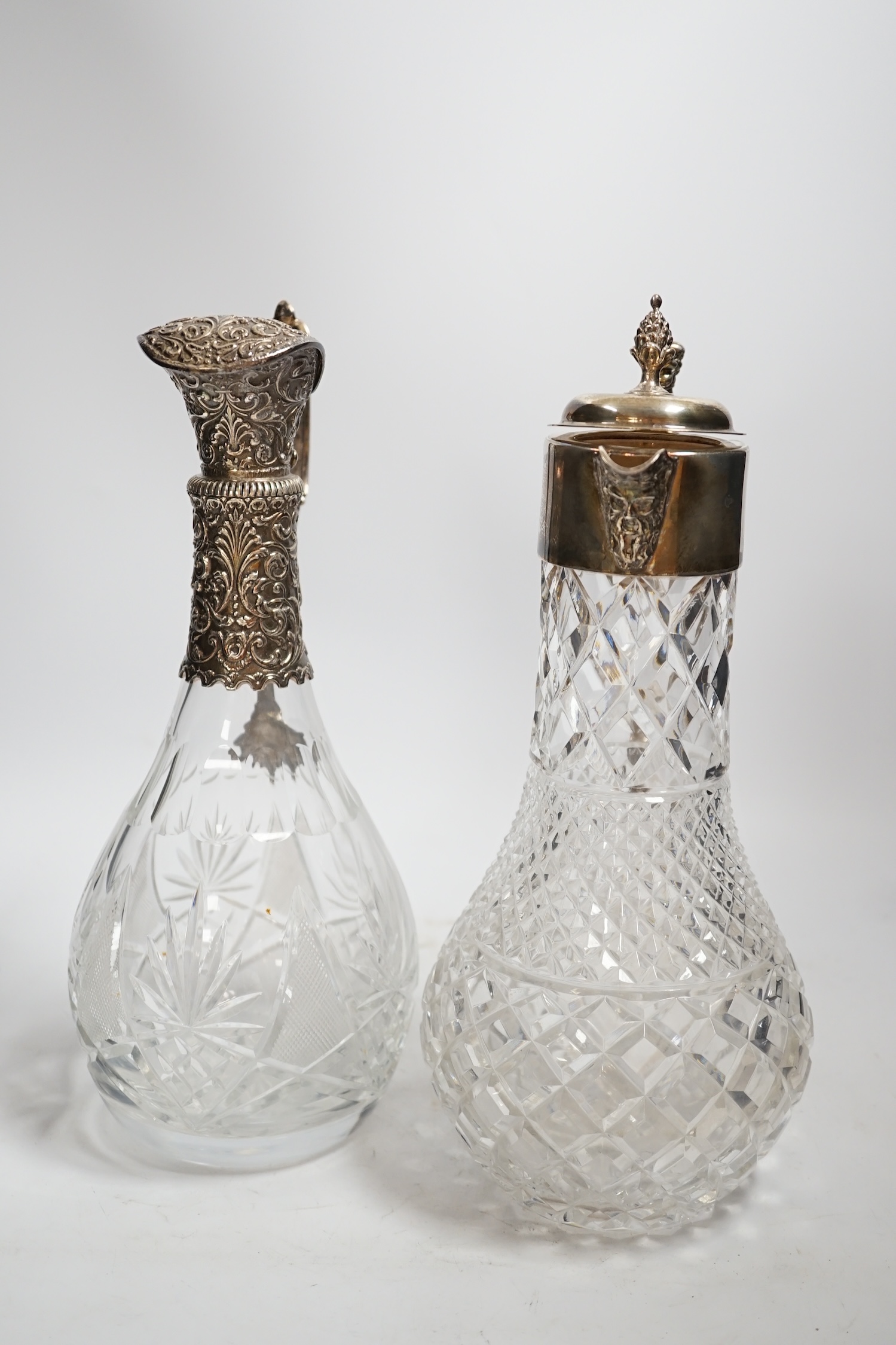 A 1970's silver mounted cut glass baluster claret jug, 31.3cm and one other 800 standard white metal mounted cut glass claret jug.